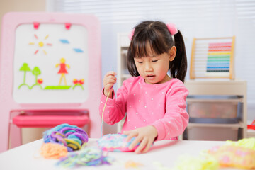 A young girl was creating a craft at home