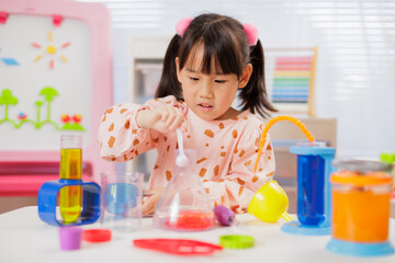 A young girl was conducting a science experiment at home.	
