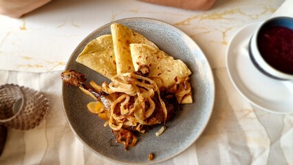 Duck with cabbage and potato pancakes is a traditional Czech dish often served on festive occasions. The duck is typically roasted until tender and flavorful, seasoned with salt and caraway seeds, and