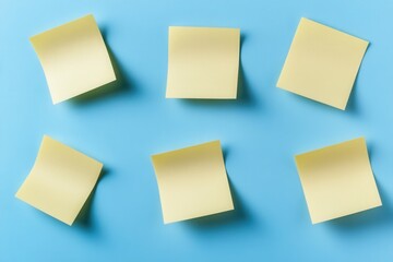 Fototapeta premium Yellow sticky notes on a blue background, concept of planning and organization.