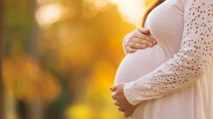 An expectant mother with a tender hand on her belly, looking thoughtfully into the distance as she experiences the nervous excitement and anticipation that comes with the final sta