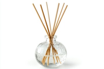 Decorative glass diffuser with reeds set in clear liquid for home fragrance display on white background