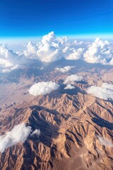 Fototapeta premium Aerial view of desert mountains, clouds, and blue sky; suitable for travel, tourism