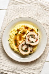 Pork loin stuffed with mushrooms, cheese, sun dried tomatoes in gravy sauce served with mashed potatoes