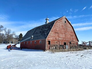 Very old Gothic livestock barn in a midwestern state enjoying the calmness of the snow