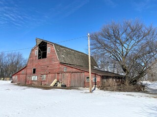 Here we have a Gambrel style barn with two side additions, in the white soft snow