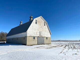 A well built barn structure with its cinderblock foundation in the snow