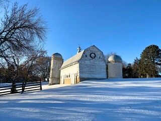 An old wooden barn in the snow decorated for the holidays