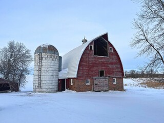 Another commanding facade of an old livestock barn and silo still standing on the rural countryside
