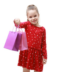 Cute little girl with shopping bags on white background