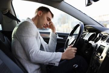 Obraz premium Tired driver sleeping in his modern car