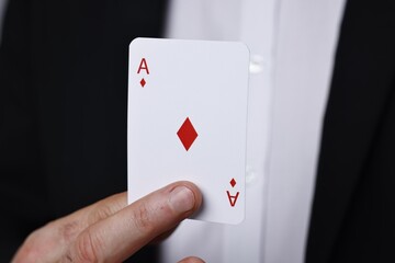 Professional illusionist with one playing card, closeup