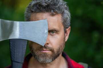 Brutal lumberjack portrait, copy space. Brutality and masculinity. Hispanic man logging with axe....