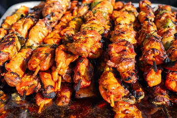Chicken on BBQ grill. Barbecue grill. Grilled chicken shish kebab. Delicious shish kebab with vegetables. Grilled BBQ pork. Skewer meat cooking on barbecue, shashlik. Shish kebab on skewer, cuisine