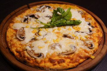 cheese mushroom and corn pizza on wooden plate