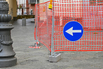 Work in progress, road sign with obligation to turn left.