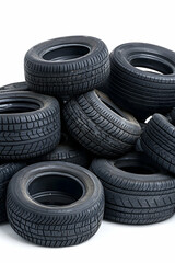 Obraz premium Stack of used car tires for recycling on white background for sale or replacement