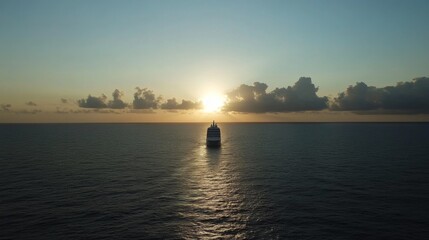 Naklejka premium Cruise ship at sunset on calm ocean. Possible use Stock photo