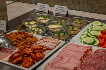 Buffet Selection with Cold Cuts, Spreads, and Fresh Vegetables

