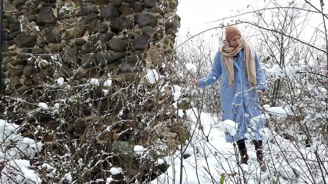 Young woman at the ruins of the Castle of Hasznos near Paszto