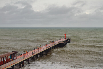 Pier and sea in bad weather. Adler, Sochi, Russia