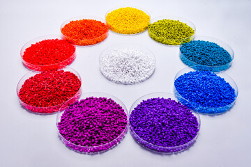 Various colors of masterbatch granules in petri dish isolated on white background,color pigment...