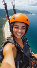 Fototapeta premium A selfie of a happy woman paragliding over the beach looking at the camera and smiling