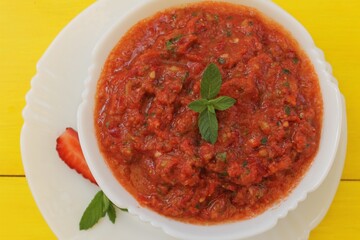 Gazpacho is a classic Spanish tomato soup flavored with mint, garlic, spices, and herbs. A must-try!
