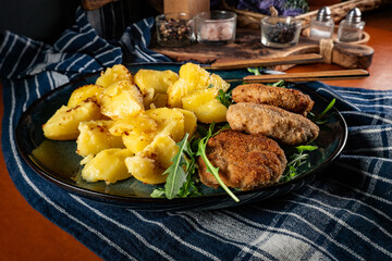 Meatballs with cheese served with boiled potatoes.