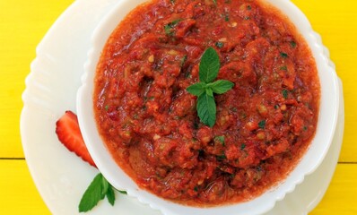 Gazpacho is a classic Spanish tomato soup flavored with mint, garlic, spices, and herbs. A must-try!