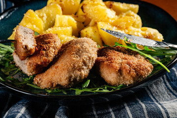 Meatballs with cheese served with boiled potatoes.