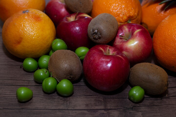 different fruits on wooden background close up
