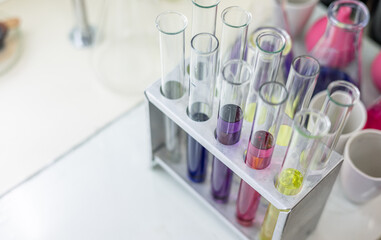 Laboratory analysis. Flask and test tubes on white table indoors, closeup. Laboratory test-tubes and retorts. Scientific equipment at laboratory.