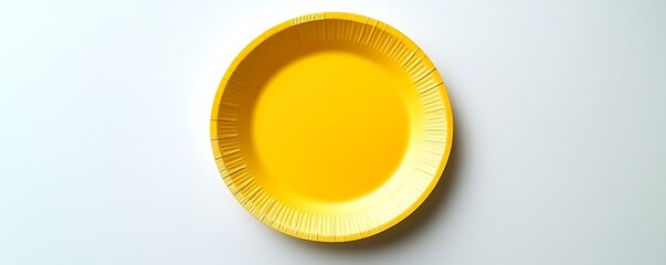 Yellow paper plate displayed on a pristine white surface, top view capture.