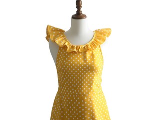 Yellow retro apron with polka dots and a ruffled neckline on a mannequin, white background.