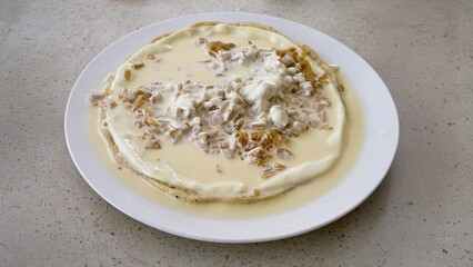 Quesillo, a typical Nicaraguan food made of cheese, cream and pickled onions. served open faced on a plate