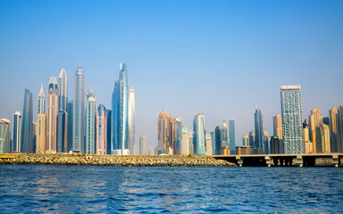 Fototapeta premium Dubai Marina beach skyscrapers, view at sunset from the boat