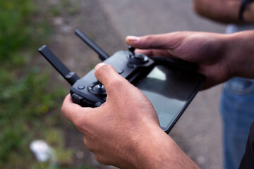 Male hands holding generic design dron remote controller doing