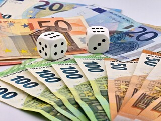 Euro money and dice on white background.
