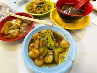 Asian cuisine variety with shrimp, vegetables, and noodle soup