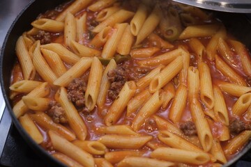 authentic photo of home pasta bolognese in the pan