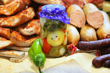 Close up composition of traditional hungarian homemade specialty foods, salami sausage etc. on farmers market for sale. Pile of delicious regional homemade products in row