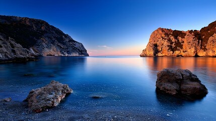 Obraz premium Tranquil Blue Ocean At Sunset With Rocky Coastline