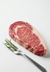 Fototapeta premium A juicy raw steak with fresh rosemary sits on a pristine background, ready for gourmet preparation.