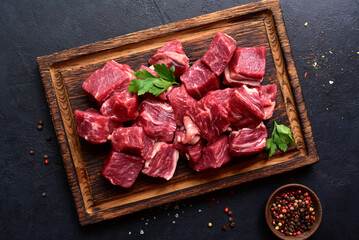 Cubes of raw organic meat ( beef or lamb ). Top view with copy space.