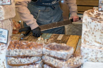 Artisan at work crafting traditional treats in a vibrant market setting