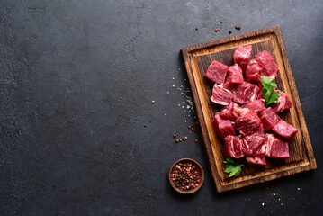 Cubes of raw organic meat ( beef or lamb ). Top view with copy space.