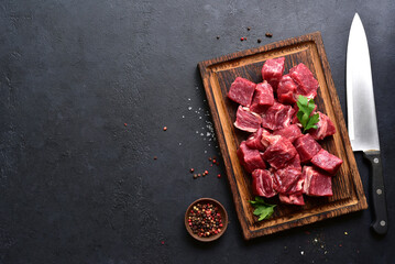 Cubes of raw organic meat ( beef or lamb ). Top view with copy space.