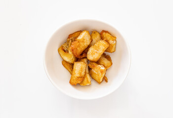 A small white bowl filled with sautéed diced chicken pieces, isolated on a white background.