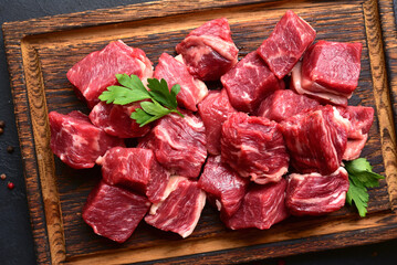 Cubes of raw organic meat ( beef or lamb ). Top view with copy space.